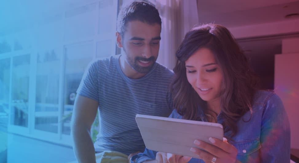 Man and woman looking over a digital tablet