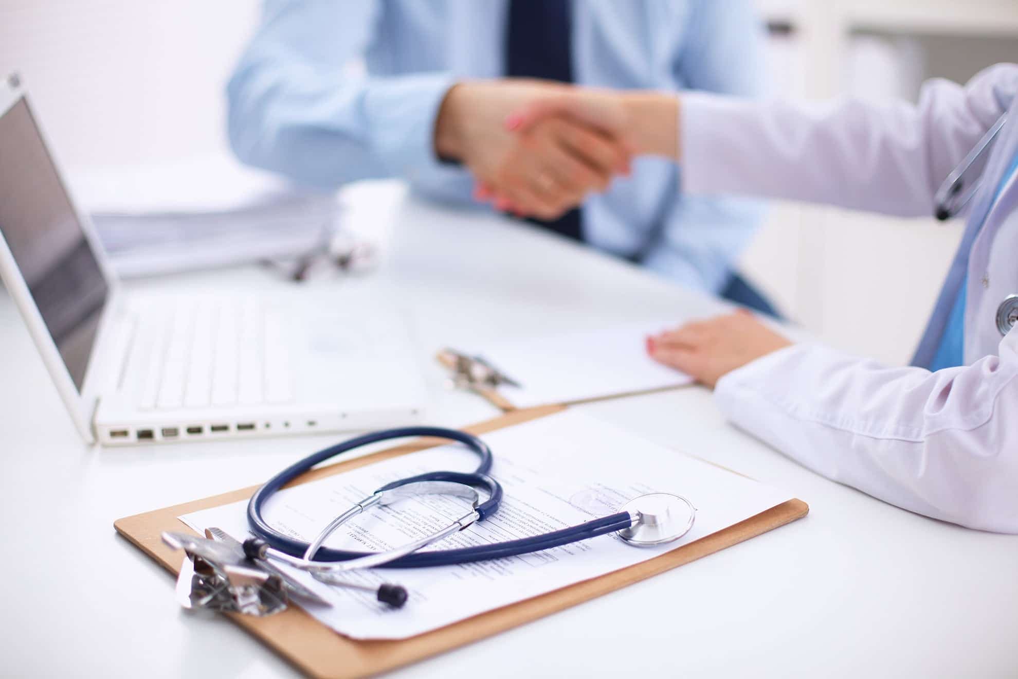 doctor and businessman shaking hands